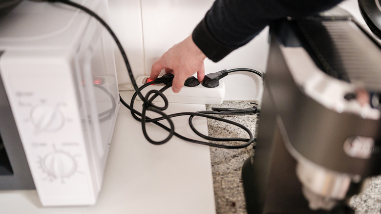 cluttered electrical cords on kitchen countertop