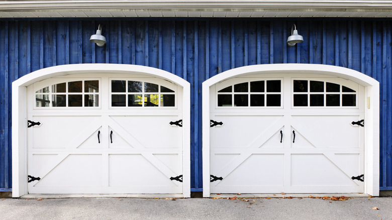 Blue house with two white carriage-style garage doors