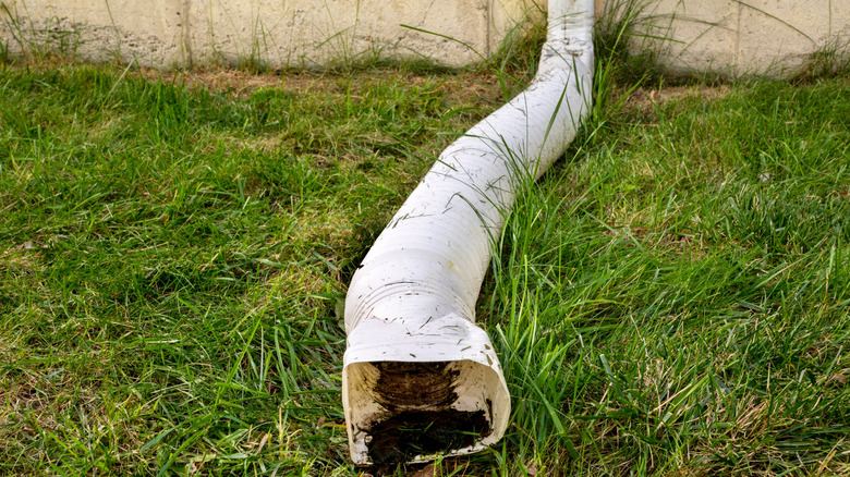 A white plastic downspout extension