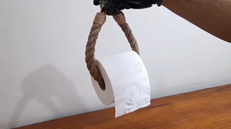 Man showing DIY toilet paper alternative made from rope