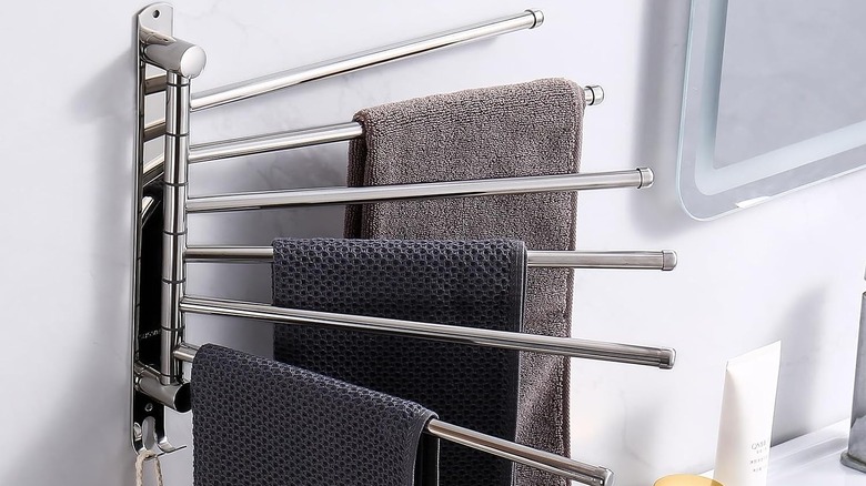 Stainless steel silver swivel rack with two towels hanging from it