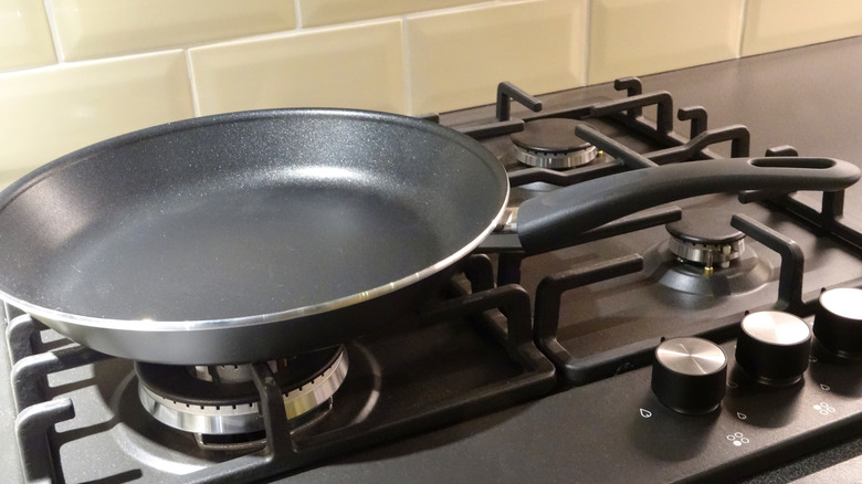 black nonstick cookware sauté pan sitting on stove eye