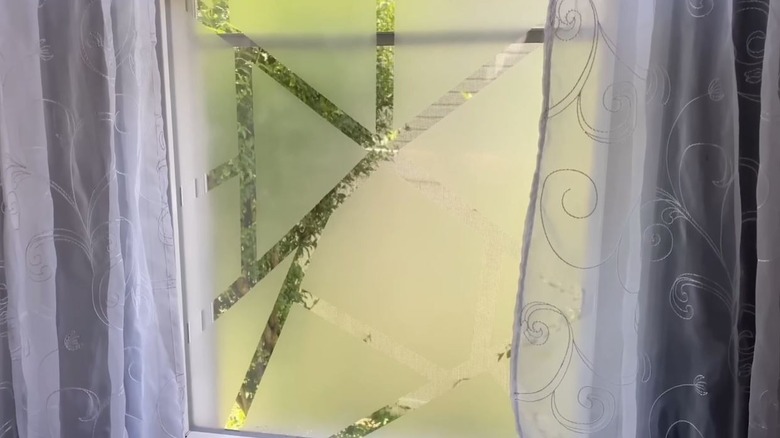 Window with design and layer of glue to help with privacy