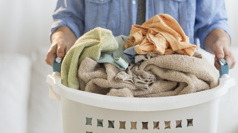 Person carrying laundry hamper
