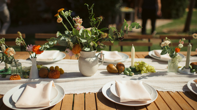 outdoor table with place settings and white table runner