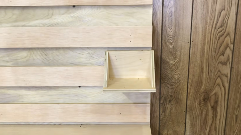 A wooden railing system with a surface attached using a French cleat