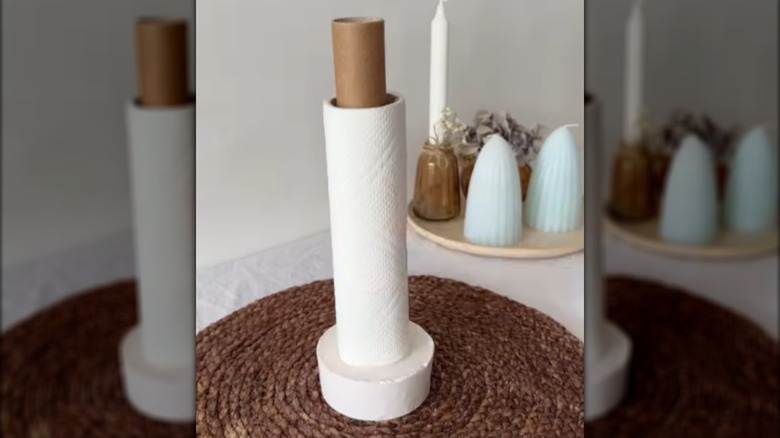 A roll of paper towel holder on a plaster and foil tube holder
