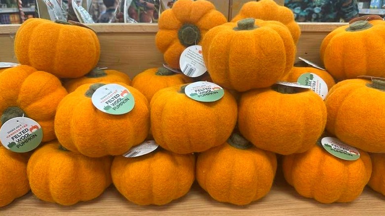 A pile of orange felted wool pumpkins at Trader Joe'