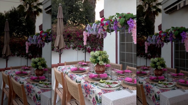 Floral arch above a decorated outdoor dining table