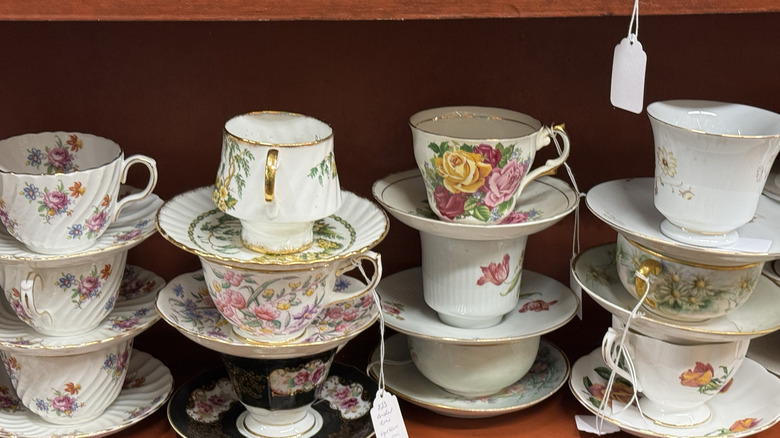 Beautiful teacups and saucers for sale in a shop.