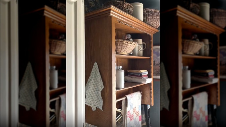 Hutch top hanging on a laundry room wall with various laundry room essentials on it
