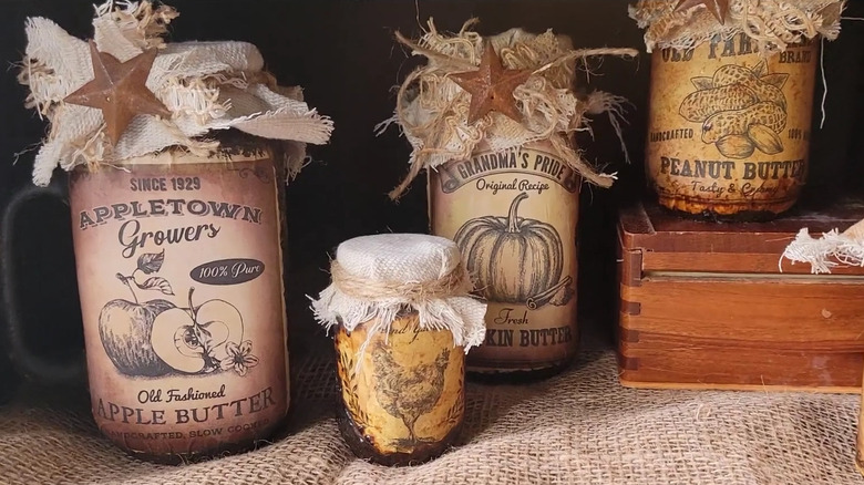 DIY mason jars with burlap, twine, and vintage food labels on rustic surface