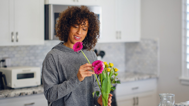 woman preparing flowers in her kitchen