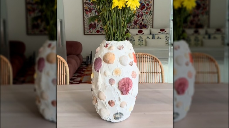 Old vase covered in plaster and seashells