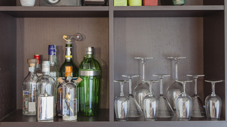 square shelving unit holding bottles and glasses