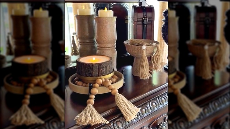 Faux-stone glasses on old-fashioned, elegant shelf with candles and high-end decor