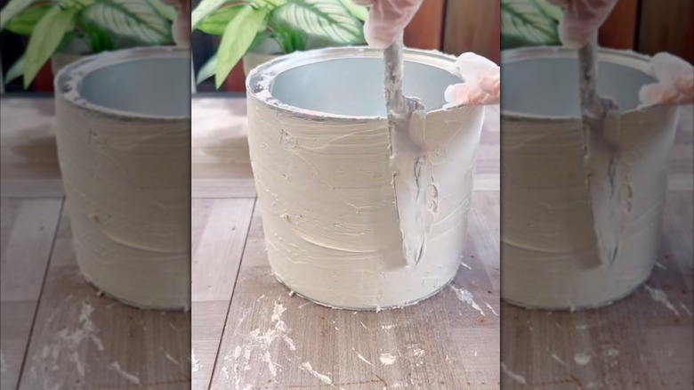 Applying spackle to coffee can