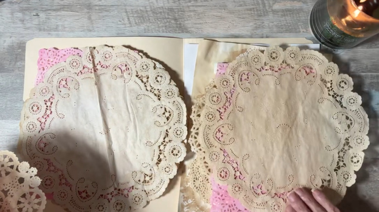 A stack of paper doilies stained with coffee.