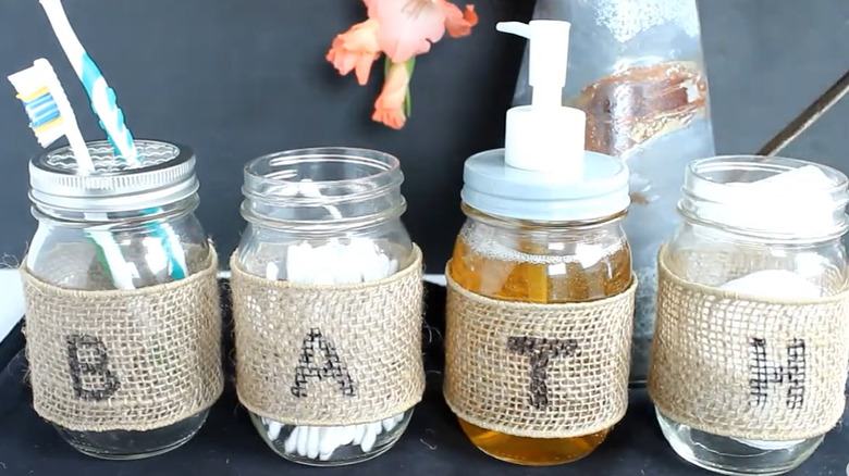 Mason jars for bathroom storage with different items stored inside