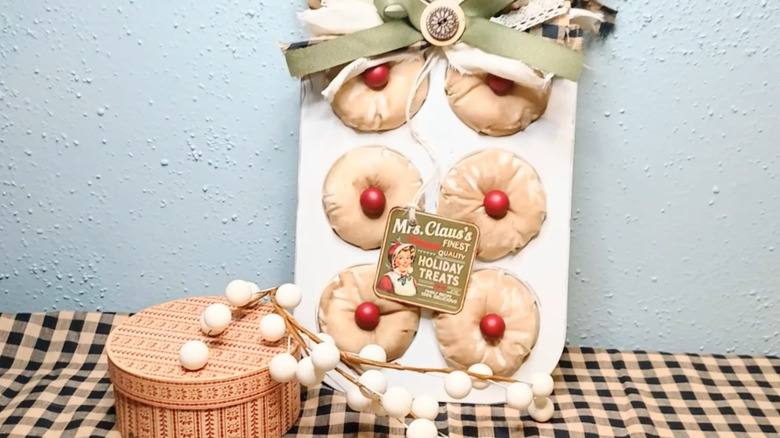 Faux cupcakes made of fabric leaning against a wall