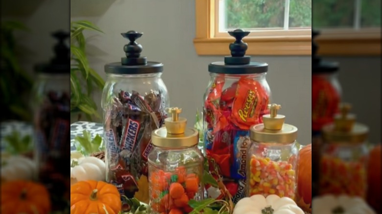 Pickle jars turned into decorative storage with candy inside of them