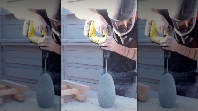 DIYer drilling into a stone to make a vase