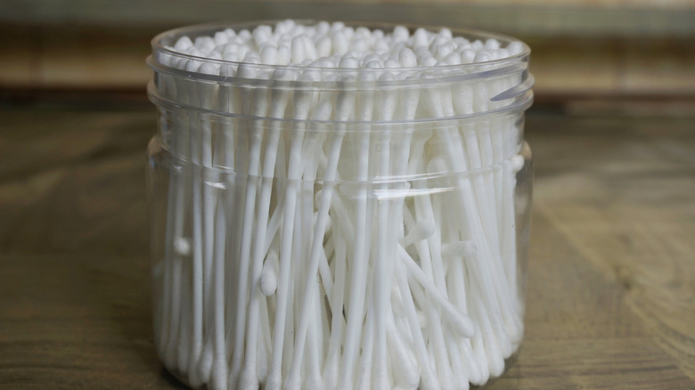 clean jar filled with white cotton swabs