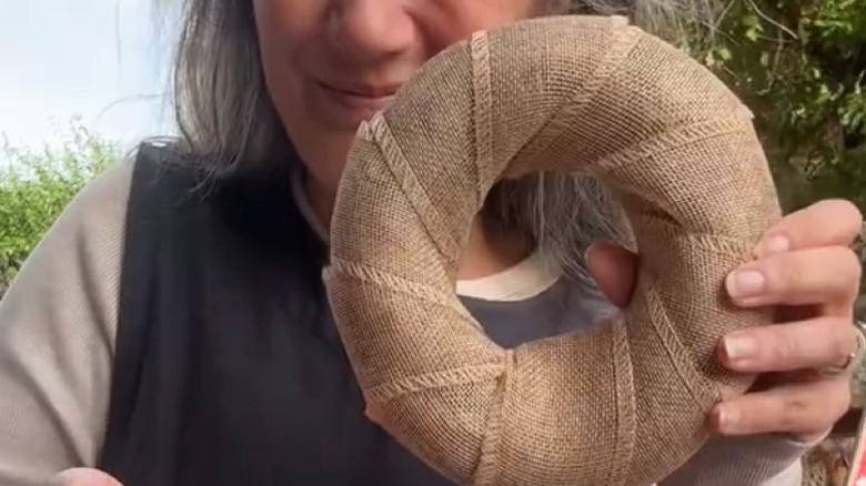 creator holds finished wreath