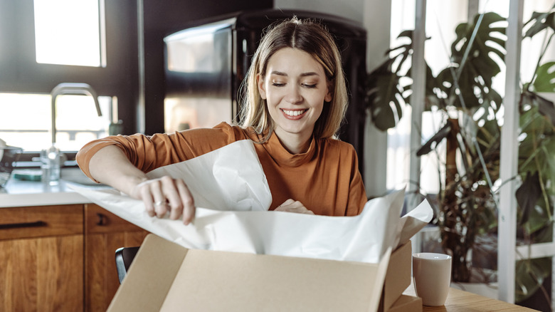 woman opening package