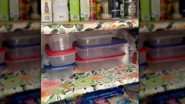 Pantry shelves covered in a floral-print peel-and-stick wallpaper