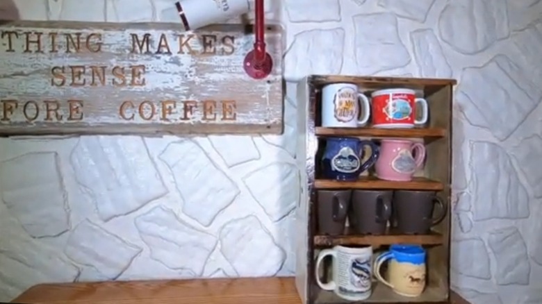 Rustic mug shelf next to coffee sign