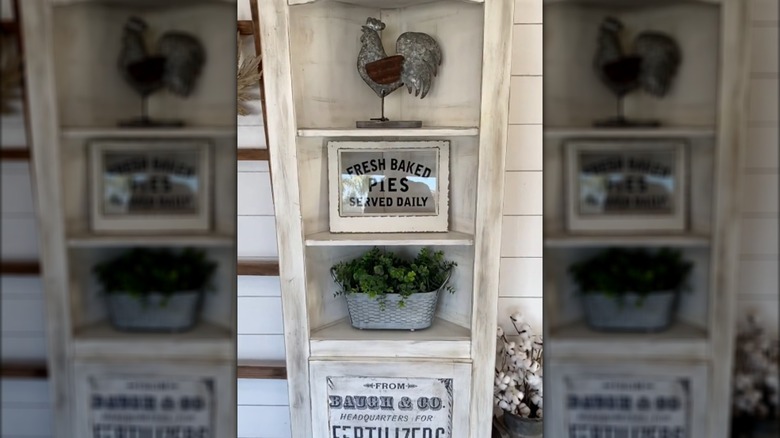 Bleached honey oak hutch with farmhouse signs and rustic decorations beside other chic decor