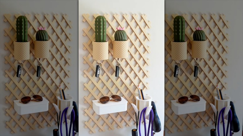 An indoor trellis storage system with baskets and bins hanging on a white wall