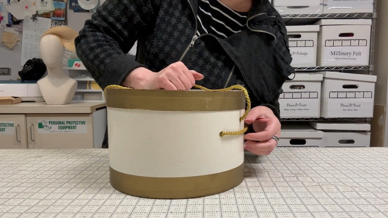 Person preparing a round box to use for a craft