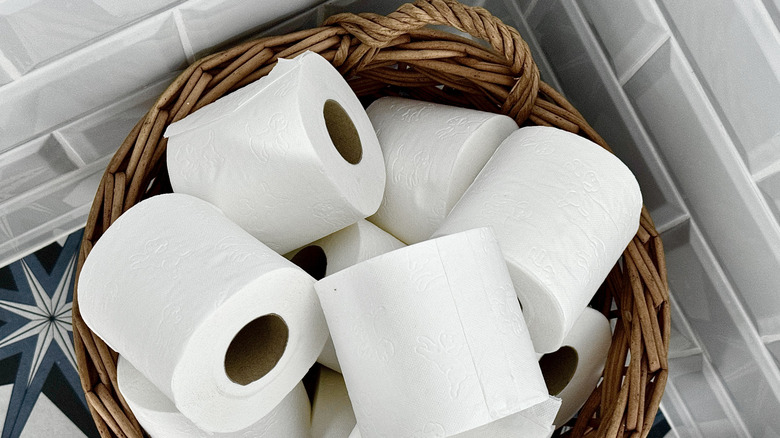 A collection of toilet paper rolls in a wicker basket