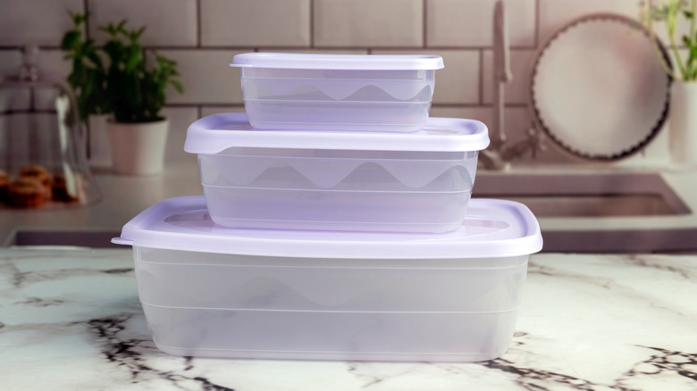Stack of three plastic containers on a countertop