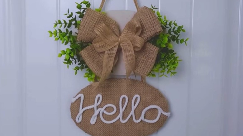 Finished DIY welcome sign on door made from lids