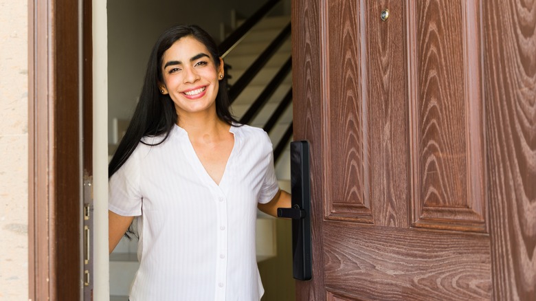 Woman opening up front door