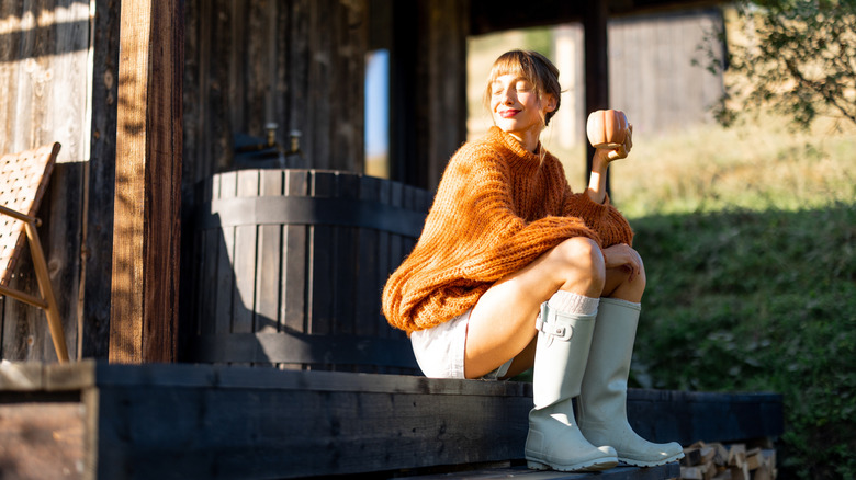 Woman sitting on porch steps