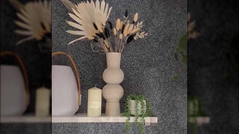 Two IKEA vases attached and painted to create a grand display wit dried flowers in it