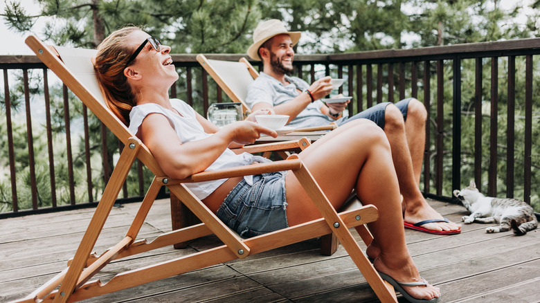 Couple sitting on patio enjoying coffee