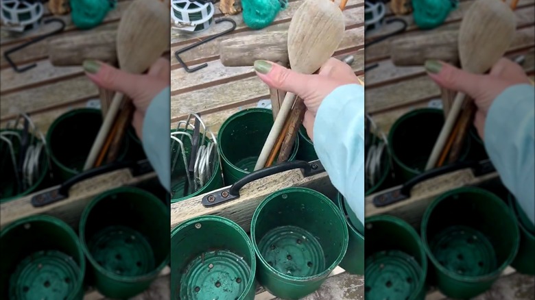 Woman putting garden tools into DIY garden caddy