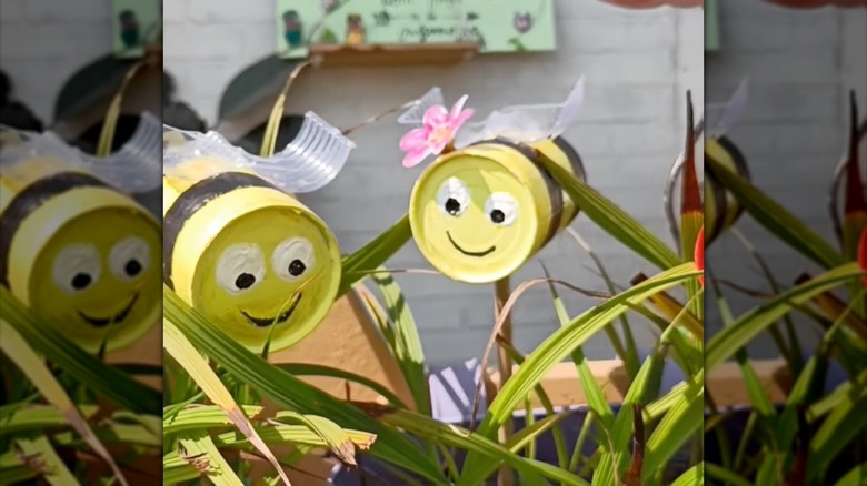 Soup can bumblebees in outdoor planter.
