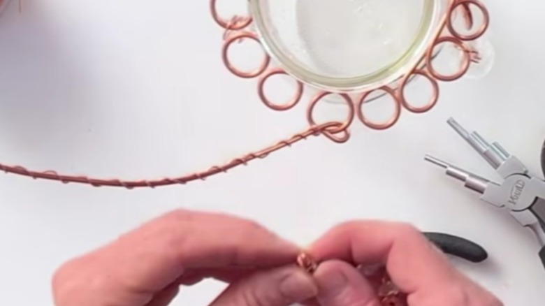 glass jar with wire-work handle