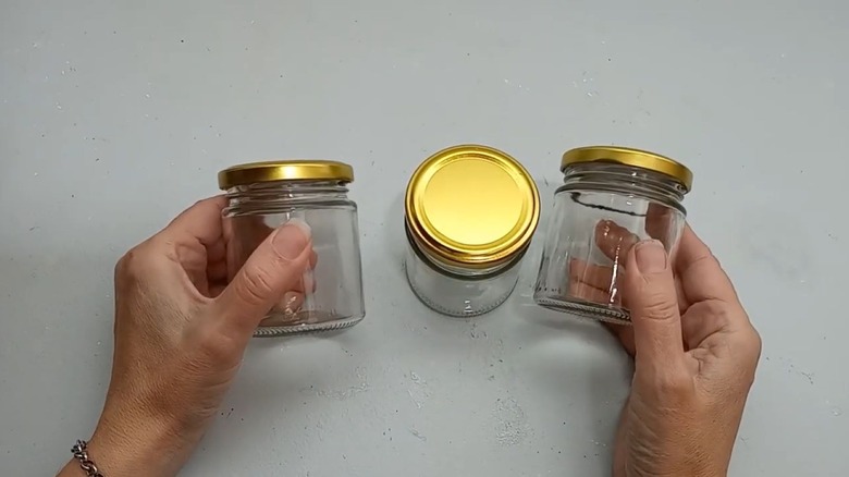 Someone starting a project with empty glass jars.