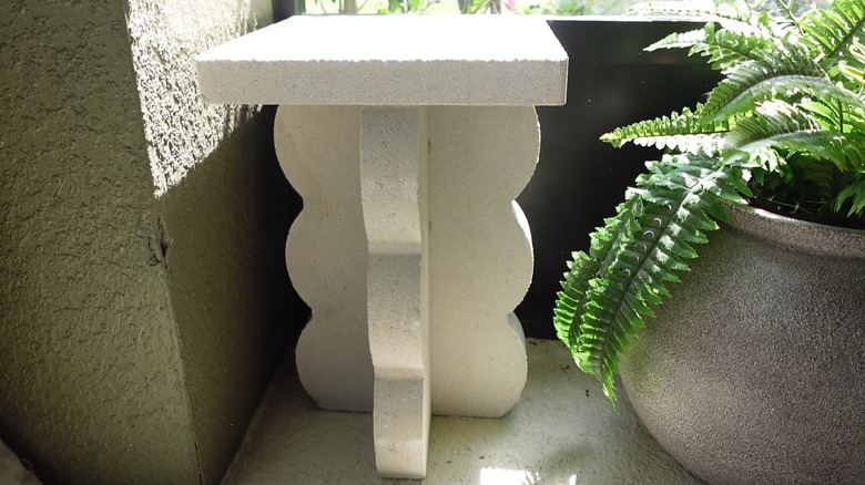 DIY white patio table made from cheap, scalloped stone pavers