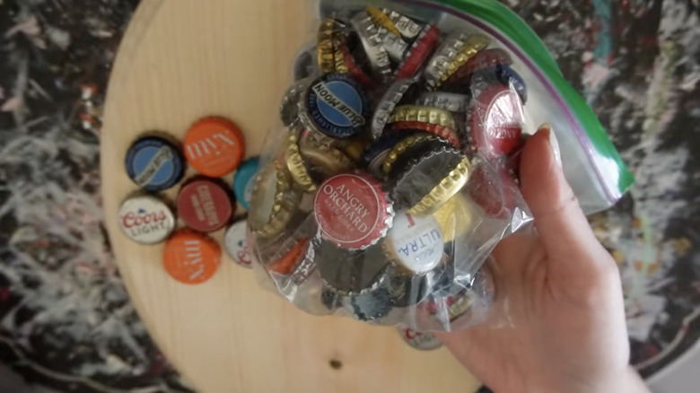 hand holding bag of bottle caps
