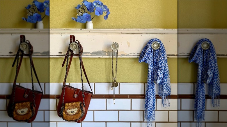 Set of door knobs on a wooden board with accessories on them