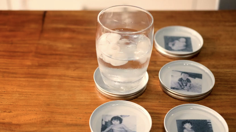 A glass of ice water sits on a customized photo coaster filed with epoxy resin