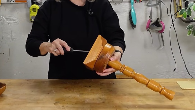 Person working on a wood candle holder